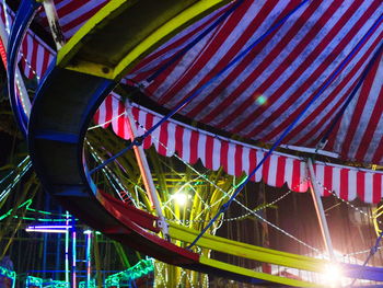 Low angle view of illuminated ferris wheel at night