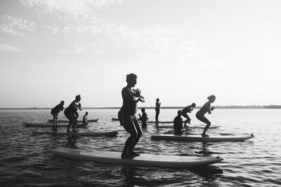 People on sea shore against sky