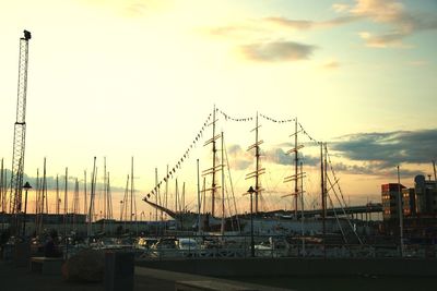 Boats in harbor at sunset