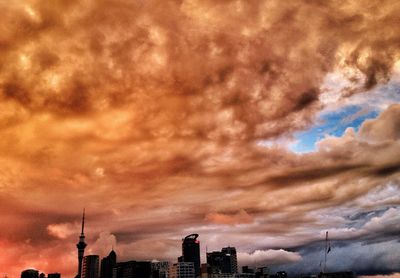 Buildings against cloudy sky at sunset