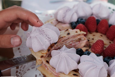 Close-up of hand holding strawberries