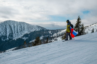 Man skiing on snow covered mountain