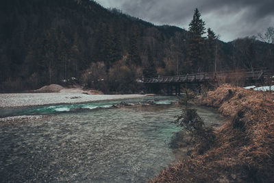 View of dam by river against sky