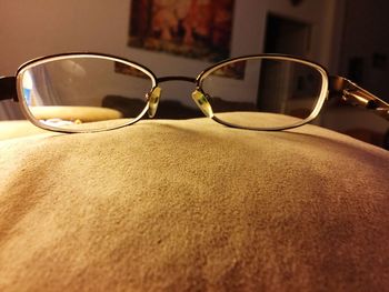Close-up of eyeglasses on sofa