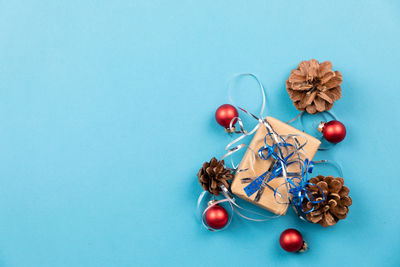 High angle view of christmas decorations on table against blue background