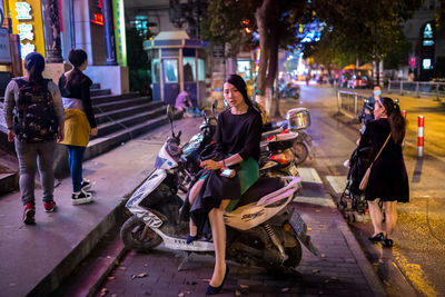 People walking on footpath at night