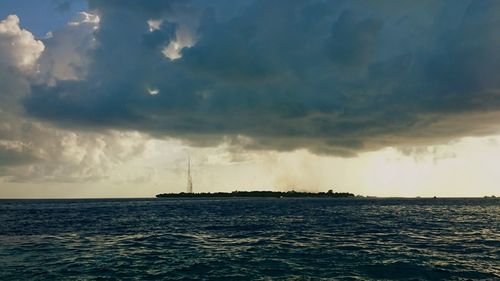 Scenic view of sea against cloudy sky