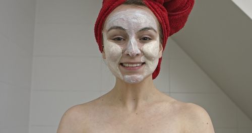 Portrait of smiling young woman in bathroom