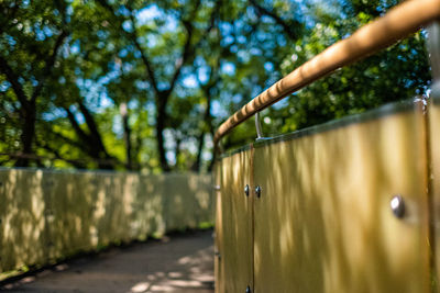 Close-up of metal fence against trees