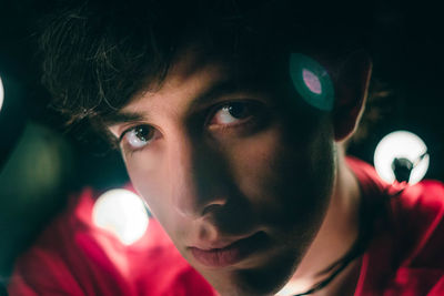 Close-up portrait of young man with illuminated lights