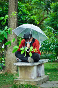 Man holding umbrella in rain