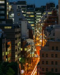 Illuminated cityscape against sky at night