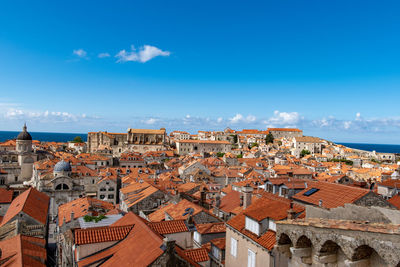 High angle view of townscape against blue sky