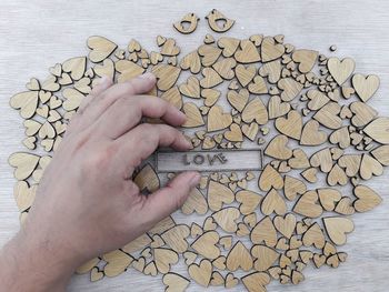 Close-up of person hand holding text on table