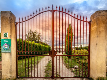 Metal gate against sky
