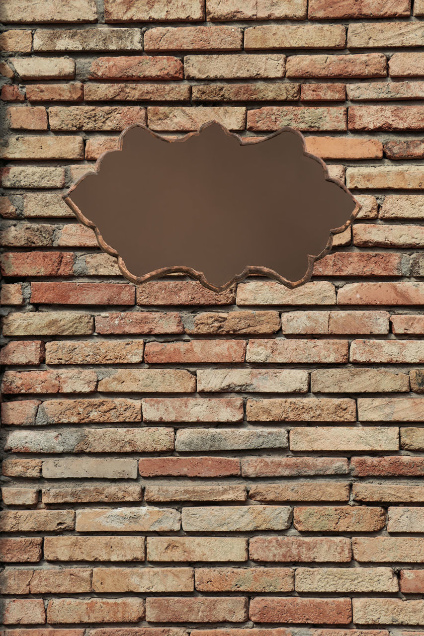 CLOSE-UP OF BRICK WALL WITH WINDOWS