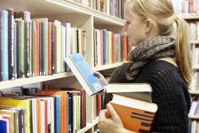 Woman choosing books in library