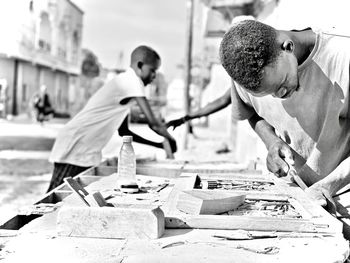 Side view of man working at workshop