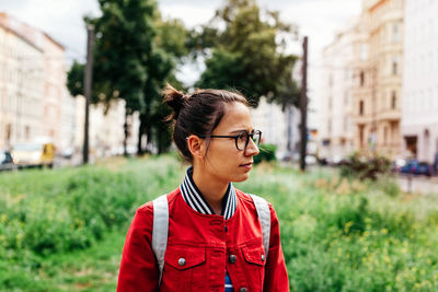Young woman standing on city street