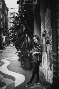 Full length portrait of woman standing in city