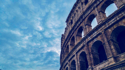 Low angle view of historical building against cloudy sky