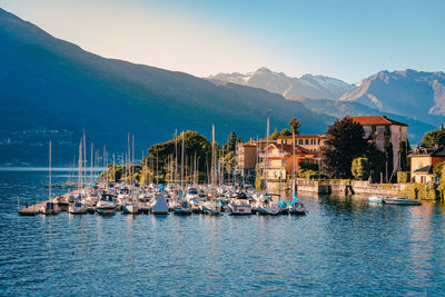 Pier on lake como with boats moored at sunset