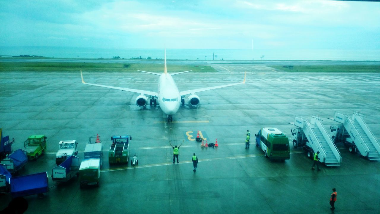 transportation, water, sea, mode of transport, sky, horizon over water, travel, blue, high angle view, cloud - sky, nature, day, road, outdoors, tranquility, car, incidental people, guidance, airport, nautical vessel