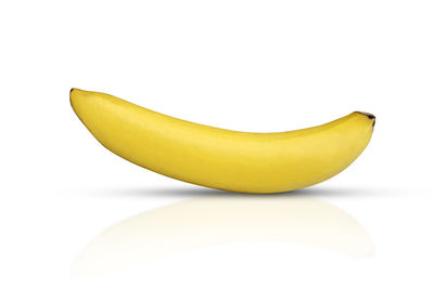 Close-up of yellow fruit against white background