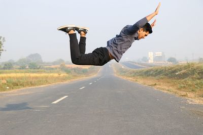 Boy jumping on road