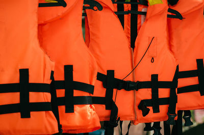 Close-up of orange flags hanging on wall