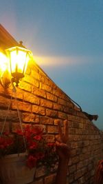 Low angle view of illuminated wall against sky