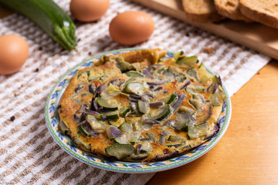 Zucchini and red onion omelette. high angle view of omelette on table