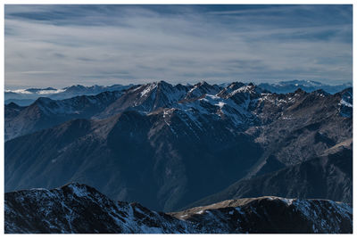 Scenic view of snowcapped mountains against sky