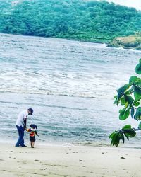 Man and woman standing on beach