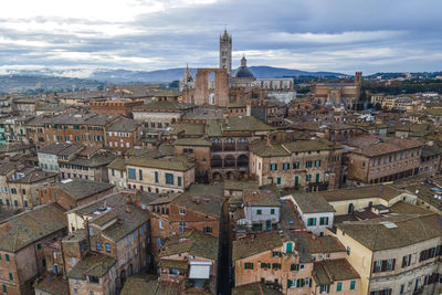 Aerial view of duomo di siena, the main cathedral in town with a residential district 