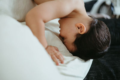 High angle view of mother and daughter on bed at home
