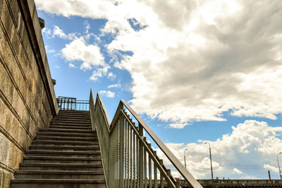 Low angle view of steps by wall