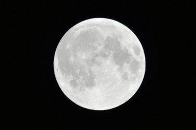 Low angle view of moon against clear sky at night