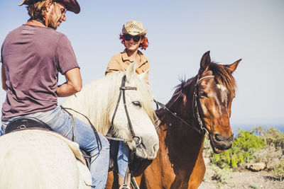 Panoramic view of people riding horse