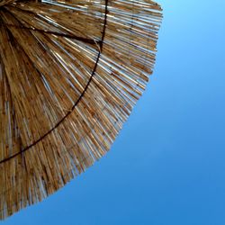 Low angle view against clear blue sky