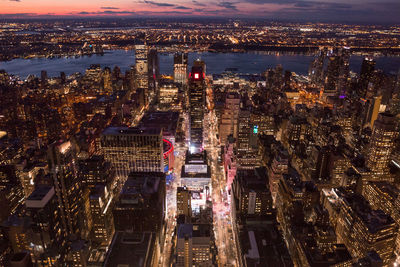 High angle view of city lit up at night