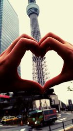 Close-up of hand against built structure