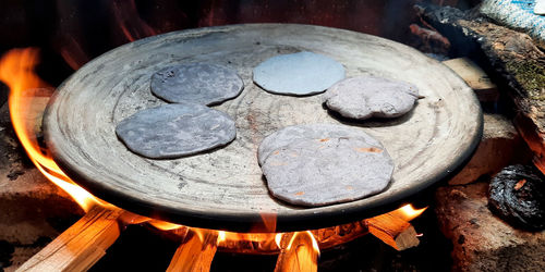 High angle view of firewood burning on wood