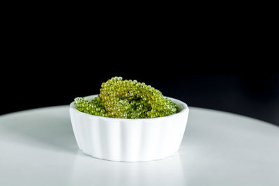 Close-up of green juice against black background