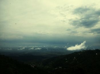 Scenic view of landscape against cloudy sky