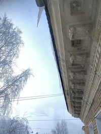 Low angle view of buildings against sky during winter