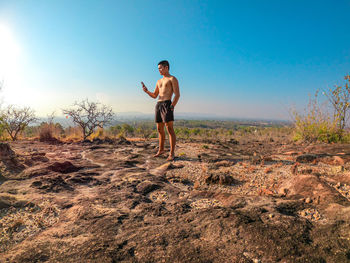 Full length of man standing on field against sky