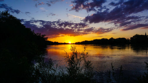 Scenic view of lake against sky during sunset