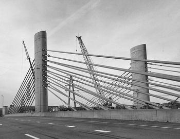 Empty road on bridge against sky