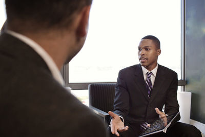 Businessmen discussing in office